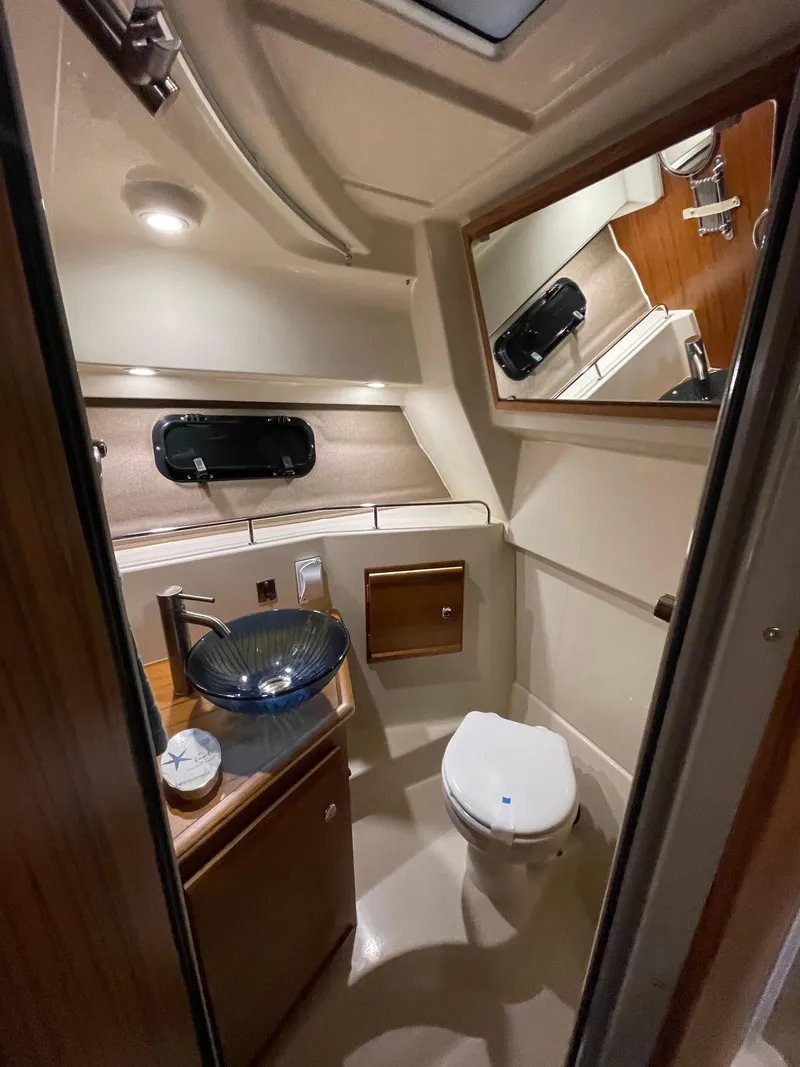 Slide: The Image of 2025 Ranger Tugs R-27 boat bathroom with modern fixtures and elegant design. - 8