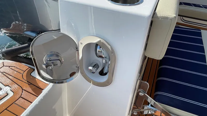 Slide: The Image of 2025 Ranger Tugs R-25 boat detail with open hatch and striped seating. - 10