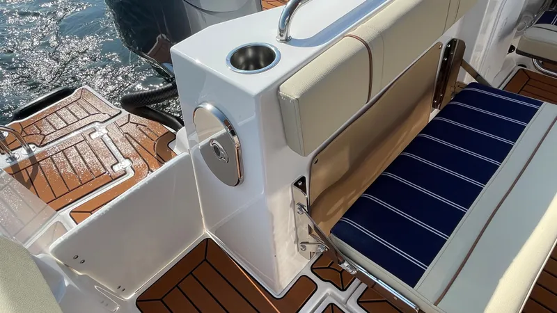 Slide: The Image of 2025 Ranger Tugs R-25 boat interior with cushioned seating and teak flooring. - 12