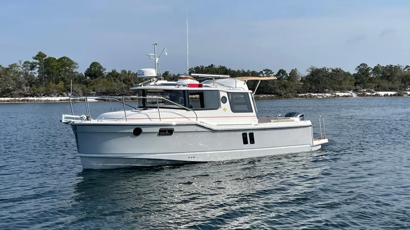 Slide: The Image of 2025 Ranger Tugs R-25 boat cruising on a calm lake. - 20