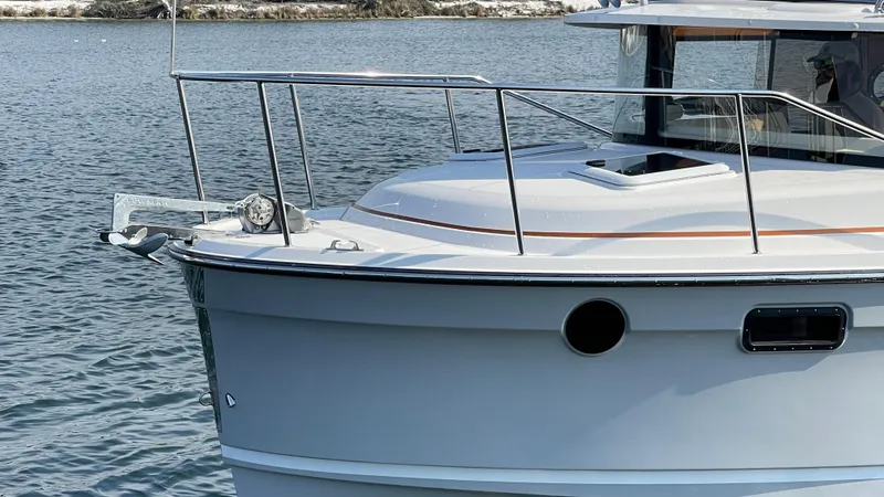 Slide: The Image of 2025 Ranger Tugs R-25 boat on water, showcasing sleek design and modern features. - 23