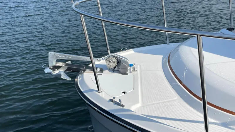 Slide: The Image of 2025 Ranger Tugs R-25 boat bow with anchor on calm water. - 27