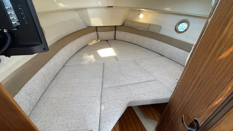 Slide: The Image of Interior cabin of 2025 Ranger Tugs R-25 with cozy seating and wooden accents. - 29