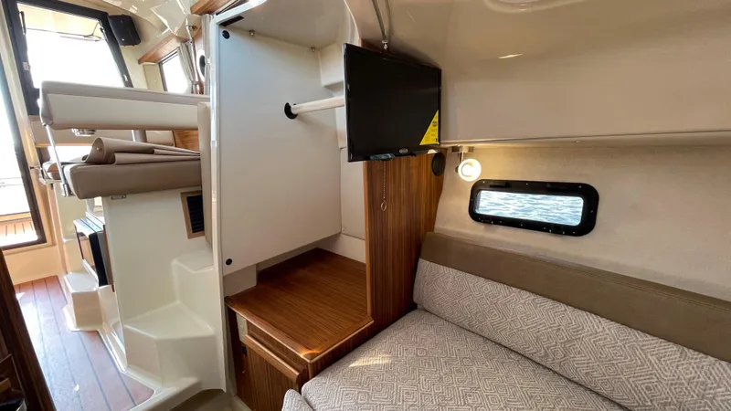 Slide: The Image of Interior of 2025 Ranger Tugs R-25 boat with cozy seating and modern amenities. - 30