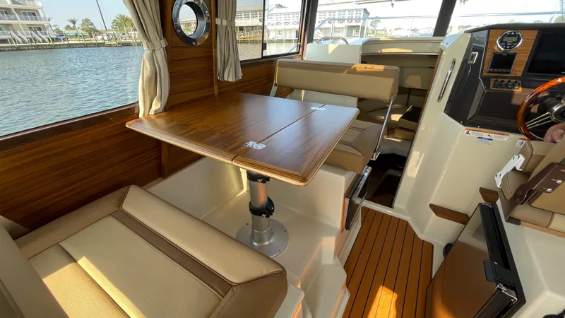 Slide: The Image of Interior of 2025 Ranger Tugs R-25 boat with wood accents and seating. - 41