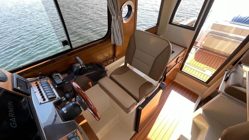 Slide: The Image of Interior of 2025 Ranger Tugs R-25 boat with helm station and wooden flooring. - 45