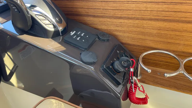 Slide: The Image of 2025 Ranger Tugs R-25 control panel with throttle and key switch. - 47