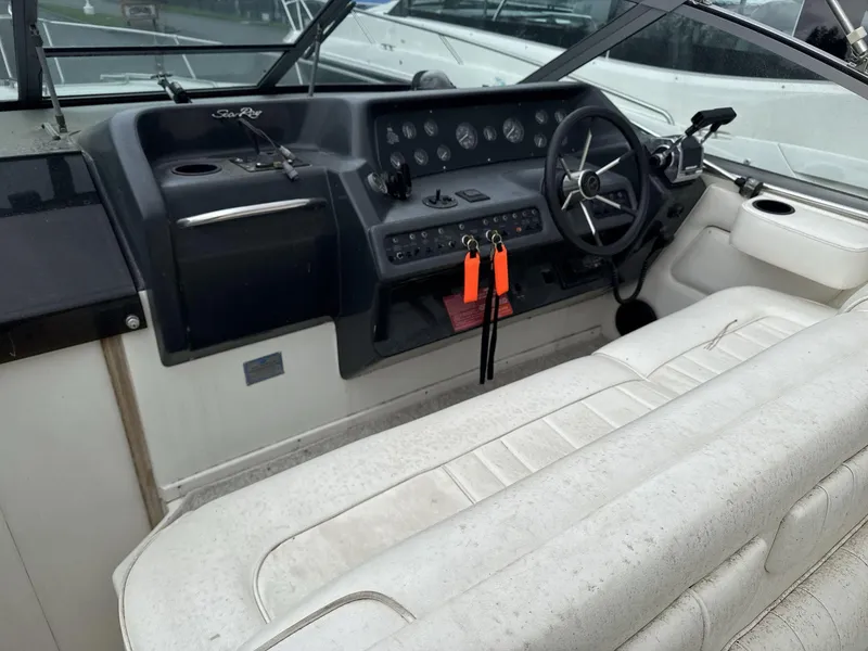 Slide: The Image of 1993 Sea Ray 300 boat cockpit with steering wheel and control panel. - 10