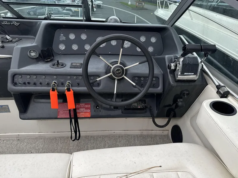 Slide: The Image of 1993 Sea Ray 300 boat dashboard with steering wheel and control panel. - 11