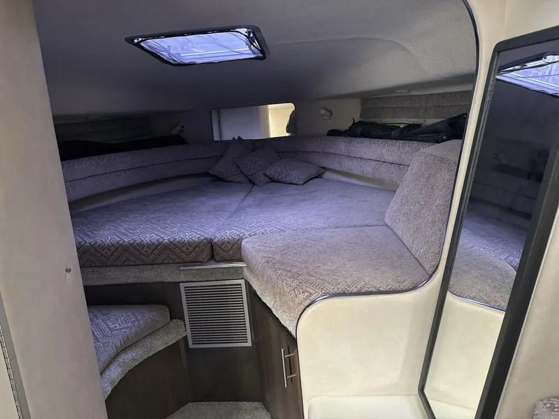 Slide: The Image of Interior cabin of 1993 Sea Ray 300 boat with cozy sleeping area. - 13