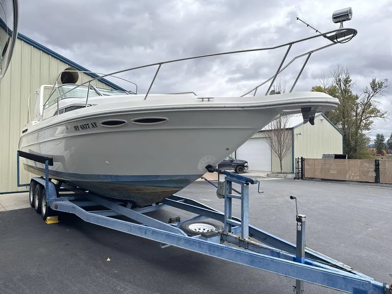 Slide: The Image of 1993 Sea Ray 300 boat on trailer, parked outdoors near buildings. - 3
