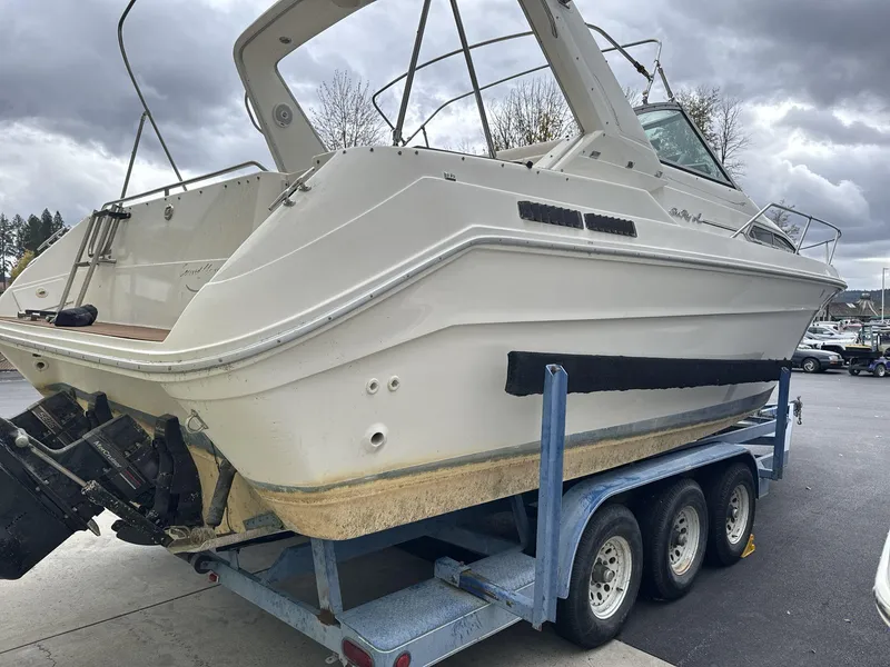 Slide: The Image of 1993 Sea Ray 300 boat on trailer under cloudy sky. - 4