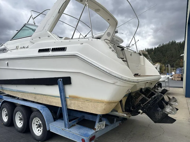 Slide: The Image of 1993 Sea Ray 300 boat on trailer, cloudy sky background. - 6