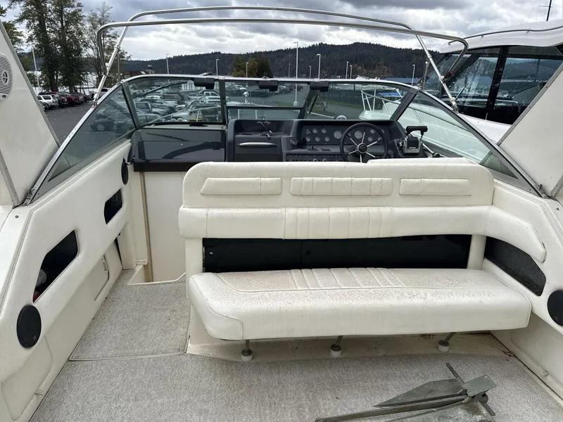 Slide: The Image of 1993 Sea Ray 300 boat interior with white seating and steering console. - 8