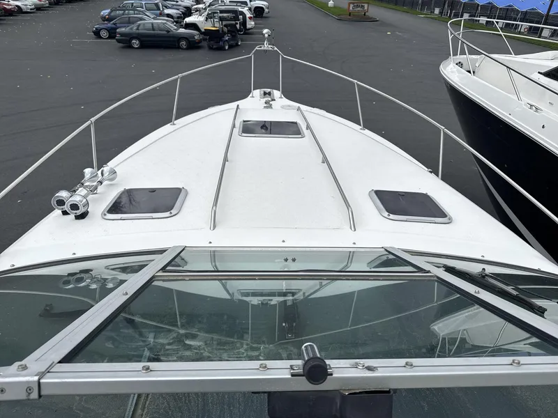 Slide: The Image of 1993 Sea Ray 300 boat on display in a parking lot. - 9