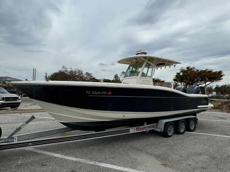 Slide: The Image of 2011 Scout 282 XSF boat on trailer in parking lot. - 0