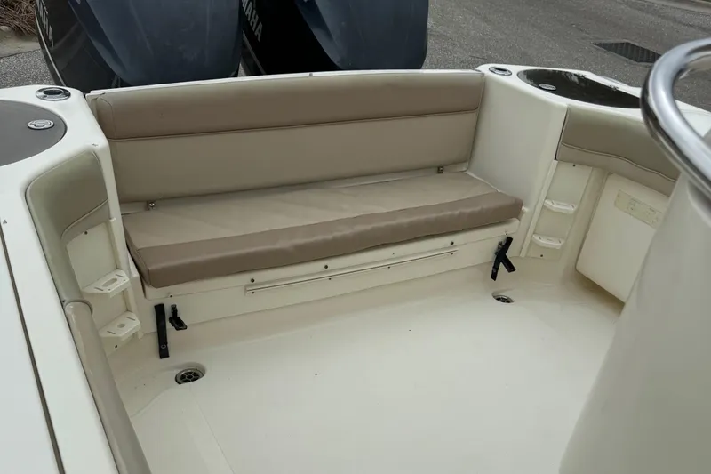 Slide: The Image of 2011 Scout 282 XSF boat interior with beige seating and storage compartments. - 10