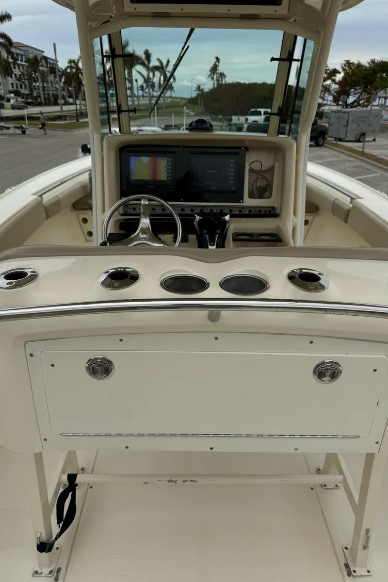 Slide: The Image of 2011 Scout 282 XSF boat dashboard with steering wheel and navigation system. - 11