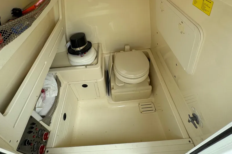 Slide: The Image of 2011 Scout 282 XSF boat interior with compact marine toilet. - 14