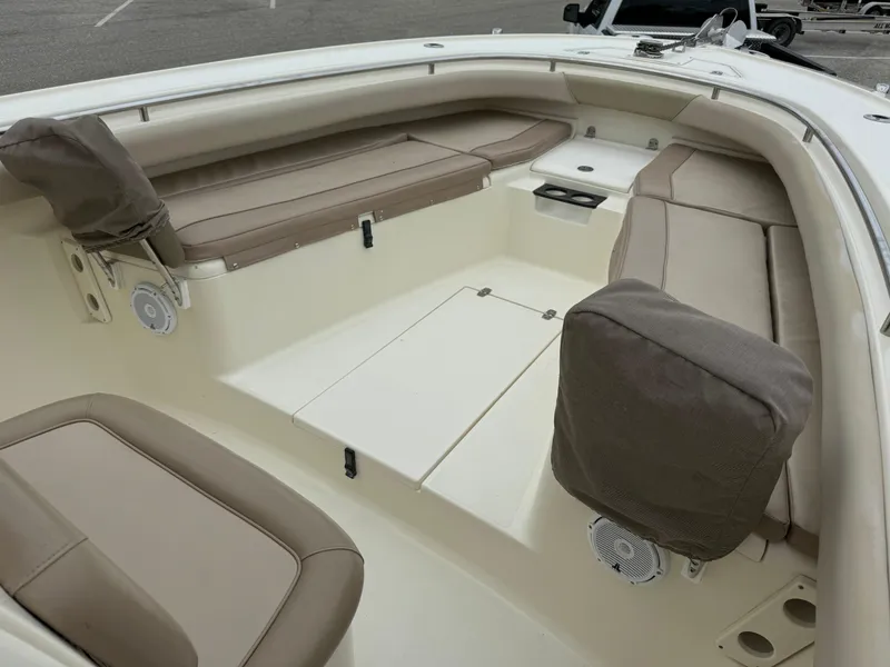 Slide: The Image of 2011 Scout 282 XSF boat interior with beige seating and storage compartments. - 4