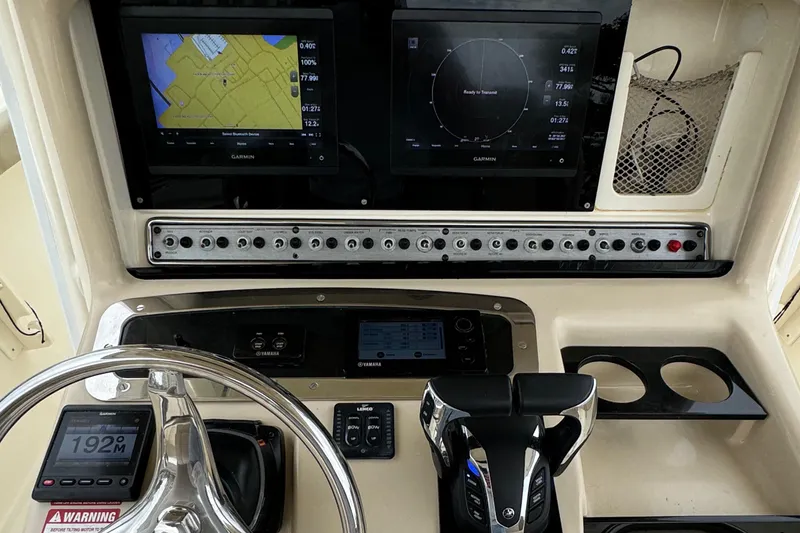 Slide: The Image of 2011 Scout 282 XSF boat dashboard with navigation screens and controls. - 7