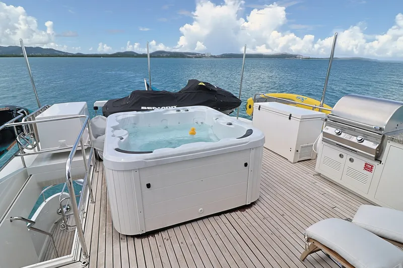 Slide: The Image of Luxurious 2013 Cheoy Lee Bravo yacht deck with hot tub, grill, and ocean view. - 19