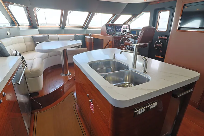 Slide: The Image of Luxurious 2013 Cheoy Lee Bravo yacht interior with modern kitchen and seating area. - 33