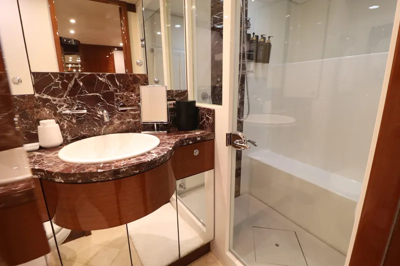 Slide: The Image of Luxurious bathroom in 2013 Cheoy Lee Bravo yacht with marble countertop and glass shower. - 40