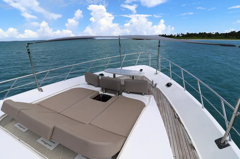 Slide: The Image of Luxury Cheoy Lee Bravo 2013 yacht deck with sun loungers, ocean view, and clear skies. - 9