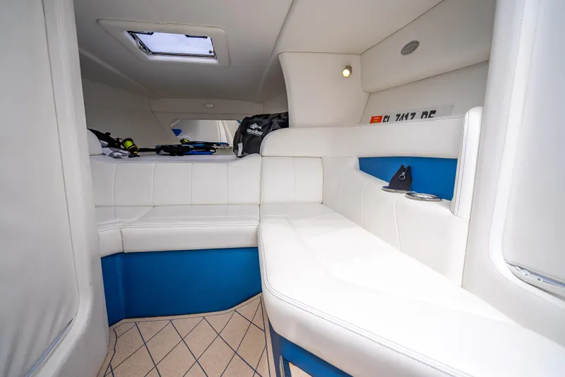 Slide: The Image of Interior of 2024 Nor-Tech 360 Monte Carlo Flyer, featuring white and blue seating. - 12