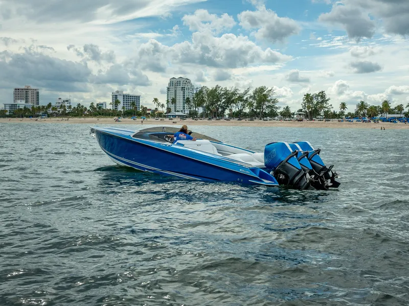 Slide: The Image of 2024 Nor-Tech 360 Monte Carlo Flyer boat on water near a city shoreline. - 29
