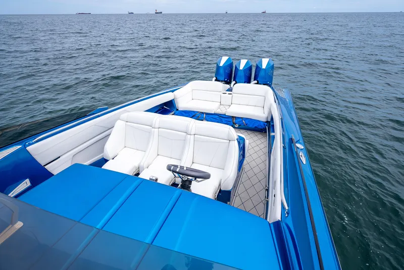 Slide: The Image of 2024 Nor-Tech 360 Monte Carlo Flyer boat on open water, featuring sleek blue design and luxurious seating. - 3