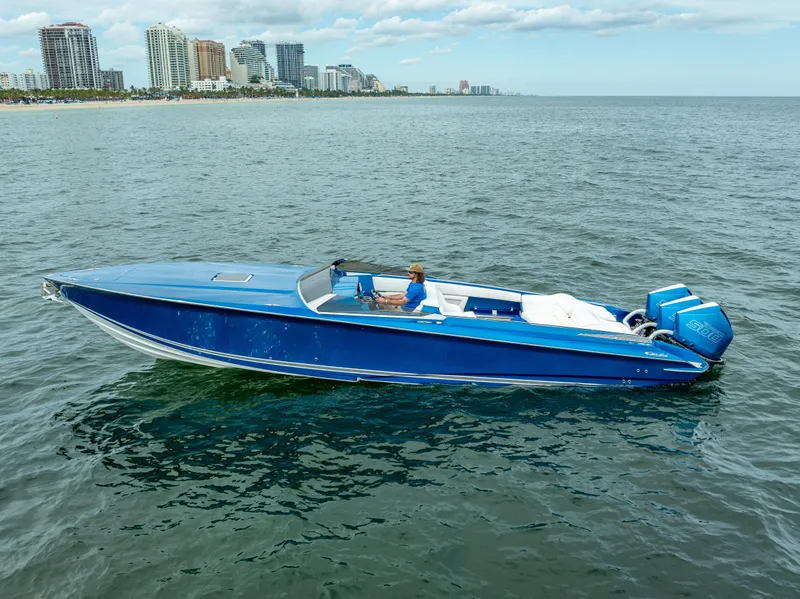 Slide: The Image of 2024 Nor-Tech 360 Monte Carlo Flyer boat on open water, city skyline in background. - 33