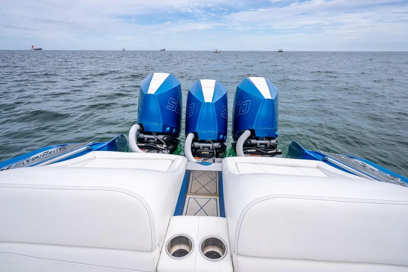 Slide: The Image of 2024 Nor-Tech 360 Monte Carlo Flyer with triple outboard engines on open water. - 42