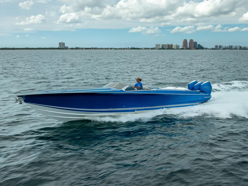 Slide: The Image of 2024 Nor-Tech 360 Monte Carlo Flyer cruising on open water, showcasing sleek blue design. - 46