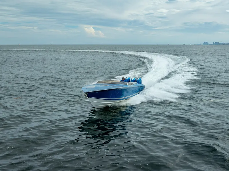 Slide: The Image of 2024 Nor-Tech 360 Monte Carlo Flyer speeding on open water, creating a dynamic wake. - 13