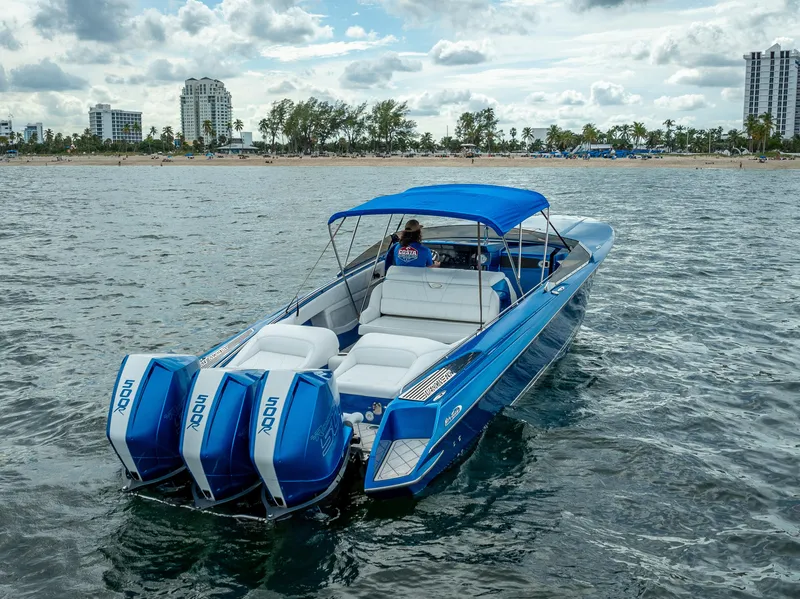 Slide: The Image of 2024 Nor-Tech 360 Monte Carlo Flyer boat on water with triple outboard engines. - 22