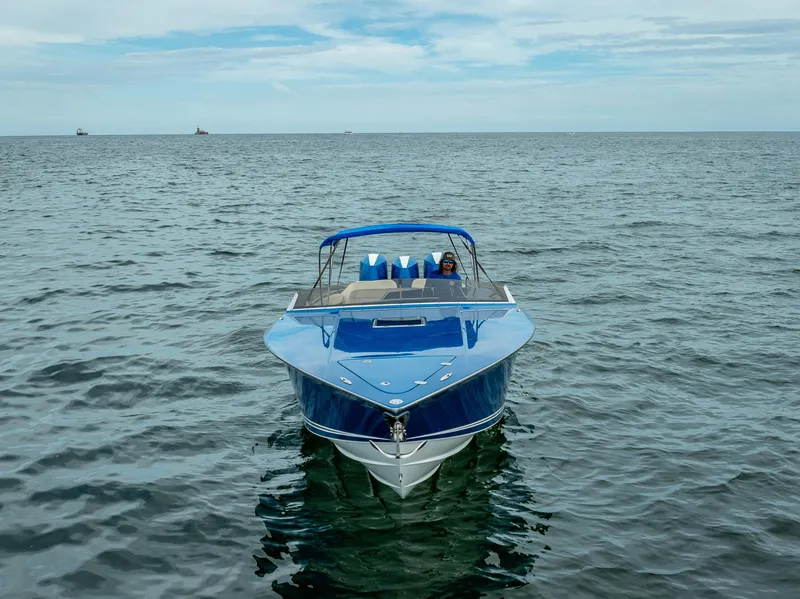 Slide: The Image of 2024 Nor-Tech 360 Monte Carlo Flyer on open water, showcasing sleek design and vibrant blue color. - 26