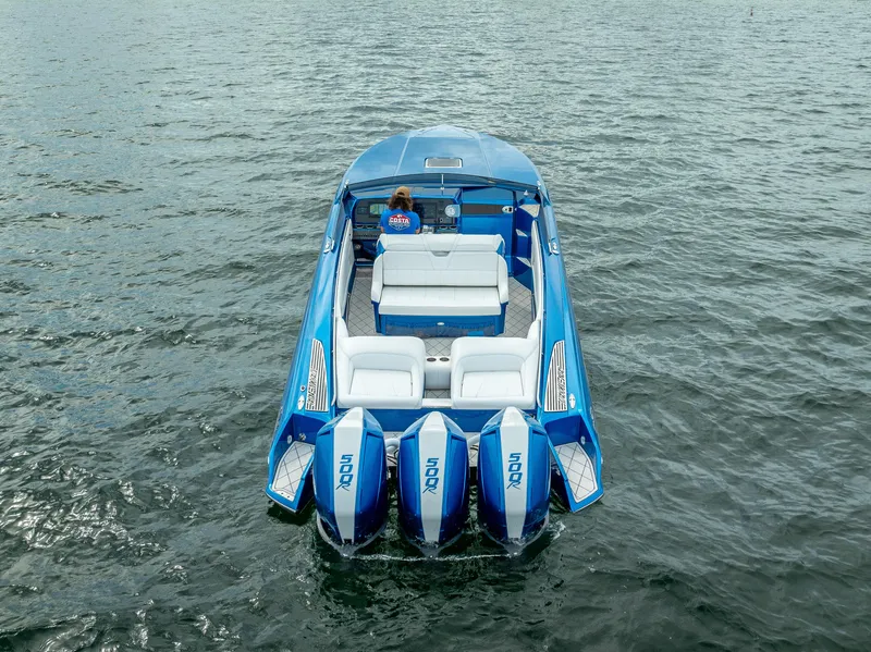 Slide: The Image of 2024 Nor-Tech 360 Monte Carlo Flyer boat on water, rear view with triple engines. - 36