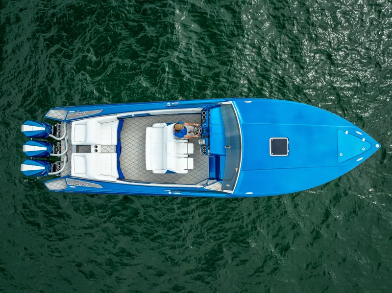 Slide: The Image of 2024 Nor-Tech 360 Monte Carlo Flyer, aerial view, vibrant blue, cruising on water. - 37