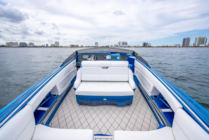 Slide: The Image of 2024 Nor-Tech 360 Monte Carlo Flyer boat interior with white seating, on open water. - 39