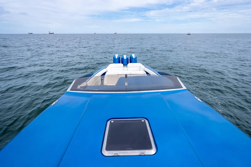 Slide: The Image of 2024 Nor-Tech 360 Monte Carlo Flyer on open sea, showcasing sleek blue design. - 4