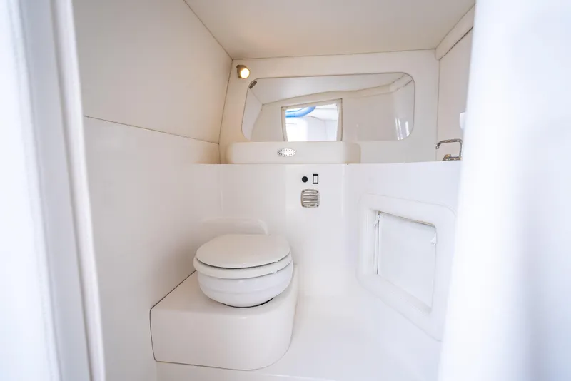Slide: The Image of 2024 Nor-Tech 360 Monte Carlo Flyer boat bathroom interior, featuring modern white design. - 43