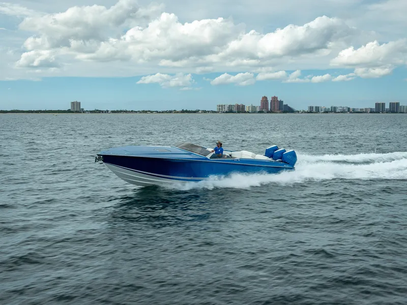 Slide: The Image of 2024 Nor-Tech 360 Monte Carlo Flyer speeding on open water under cloudy skies. - 45