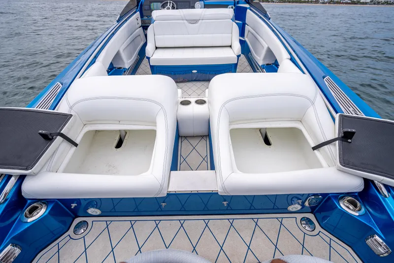 Slide: The Image of 2024 Nor-Tech 360 Monte Carlo Flyer interior with white seating and blue accents on water. - 9