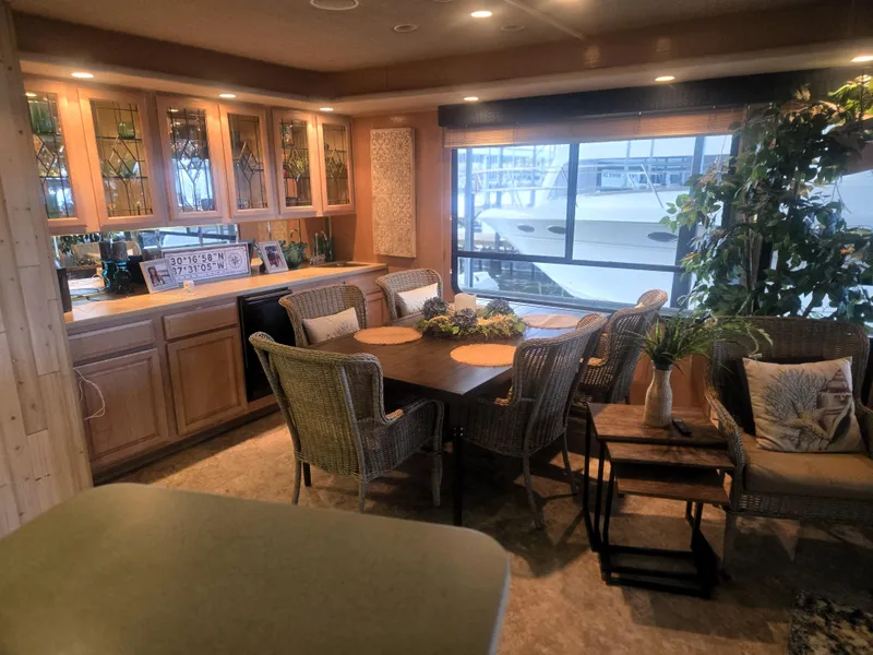 Slide: The Image of Cozy Sumerset 82'x18' 1996 houseboat interior with dining area and large windows. - 11