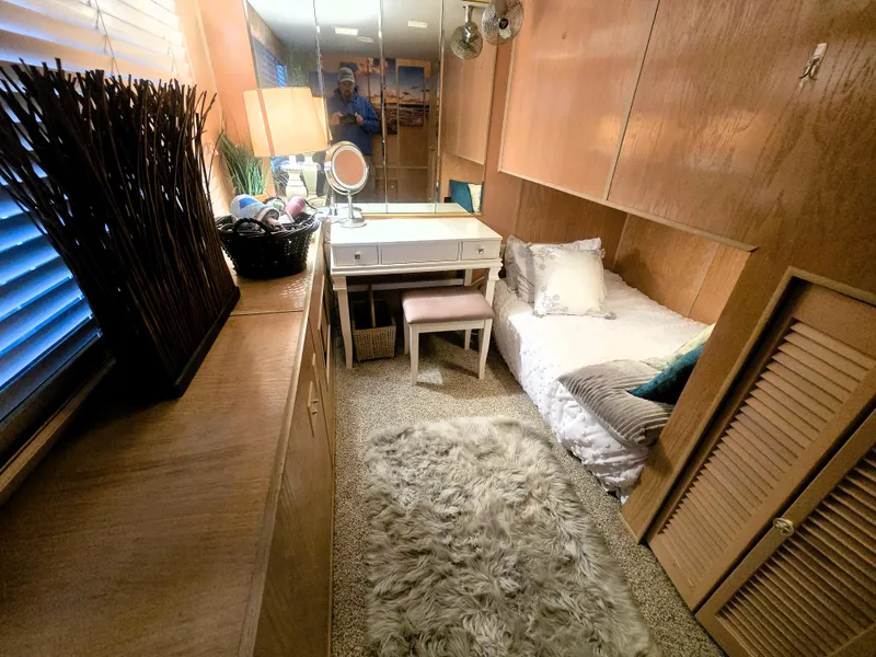 Slide: The Image of Cozy bedroom in 1996 Sumerset houseboat with wooden decor and plush rug. - 17