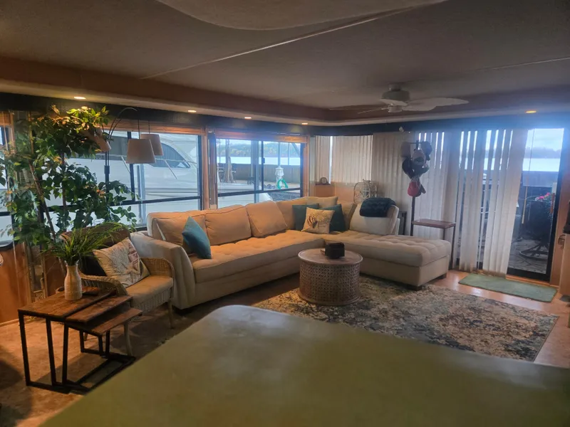 Slide: The Image of Cozy living area in 1996 Sumerset 82'x18' houseboat with large windows and comfortable seating. - 2