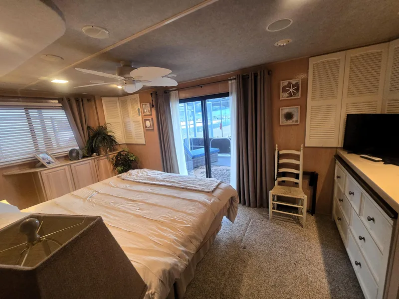 Slide: The Image of Cozy bedroom in 1996 Sumerset houseboat with sliding glass doors and modern decor. - 21