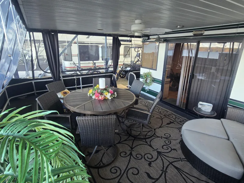 Slide: The Image of Spacious 1996 Sumerset houseboat interior with elegant seating and floral centerpiece. - 4